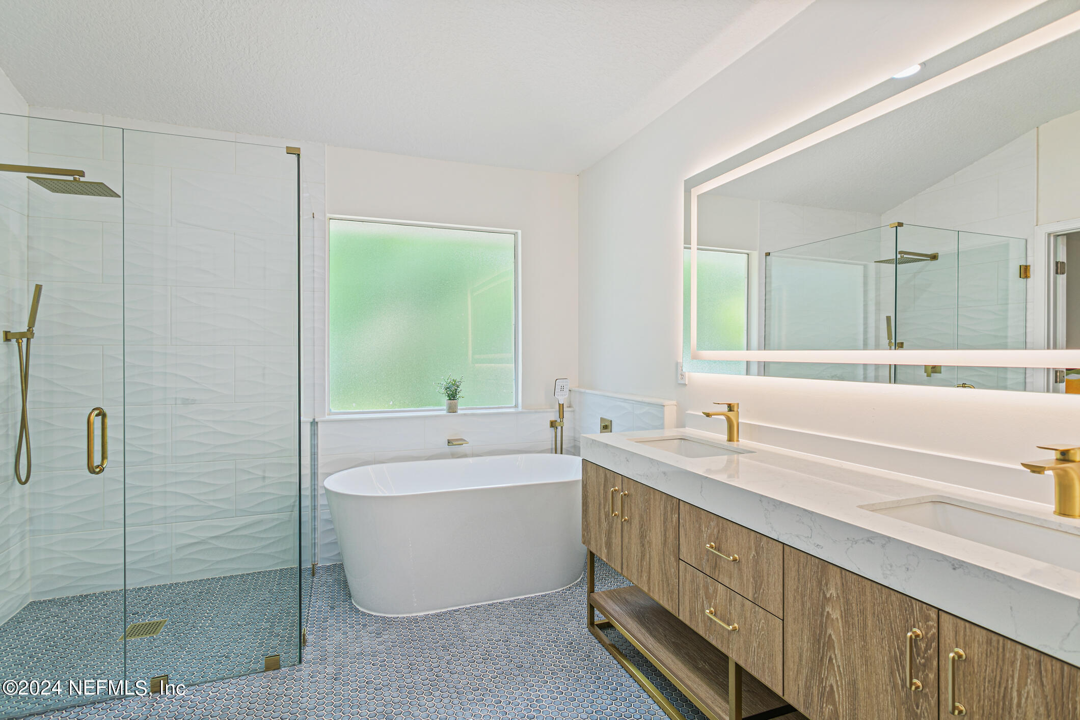 622 Cherry Street Neptune Beach, FL 32266 - Photo 23 of 77 a bathroom with a double vanity sink a large mirror a bathtub and shower