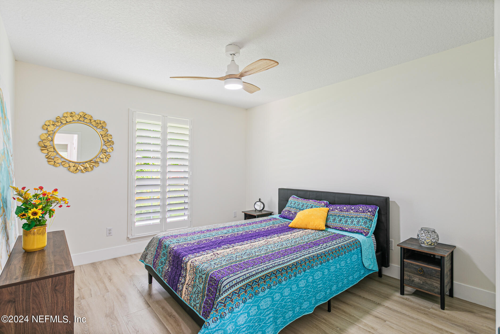 622 Cherry Street Neptune Beach, FL 32266 - Photo 34 of 77 a bedroom with a bed and a chandelier