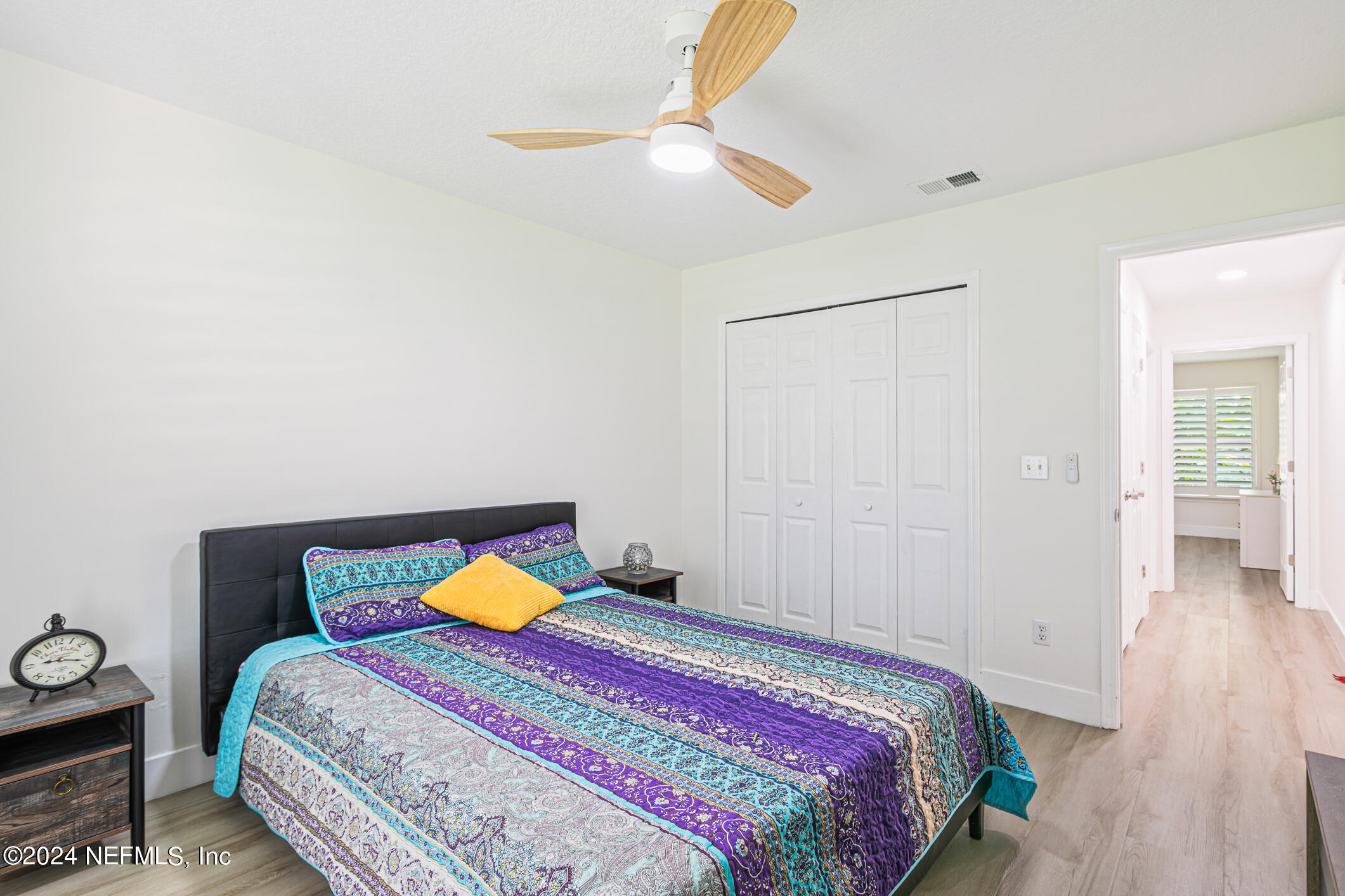 622 Cherry Street Neptune Beach, FL 32266 - Photo 35 of 77 a bedroom with a bed and a chandelier