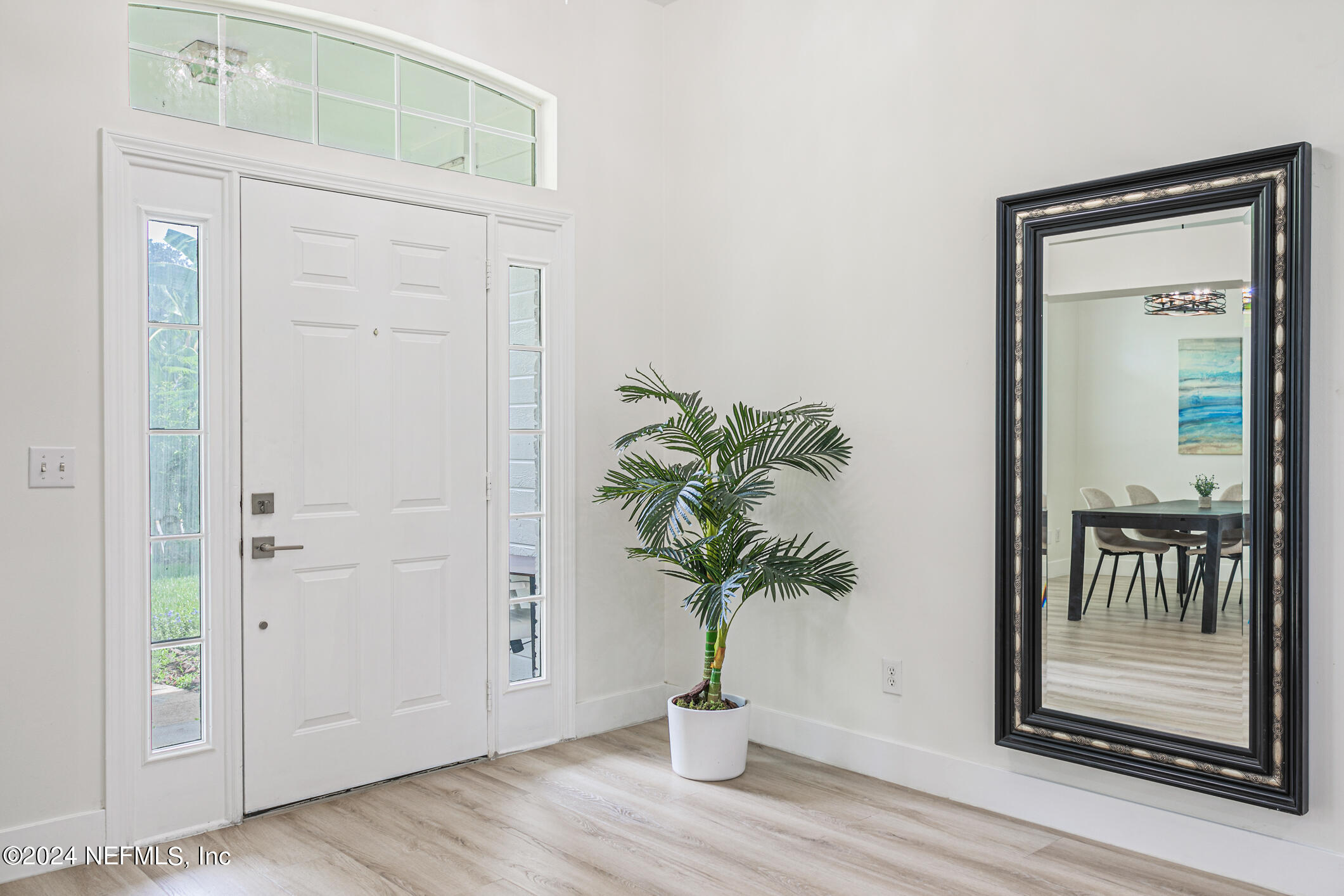 622 Cherry Street Neptune Beach, FL 32266 - Photo 4 of 77 a view of a hallway with wooden floor and a potted plant