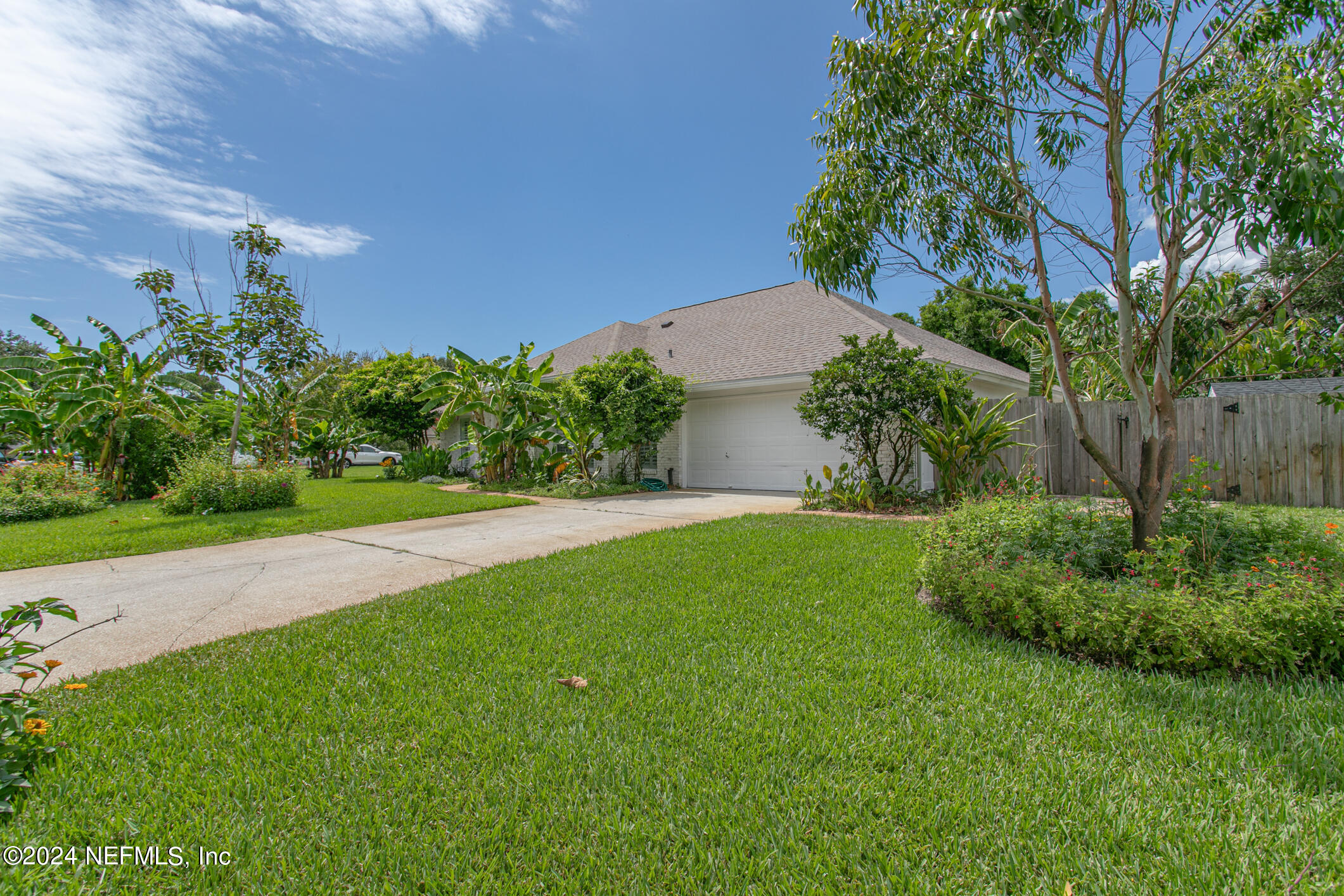622 Cherry Street Neptune Beach, FL 32266 - Photo 60 of 77 a view of a garden with a building in the background