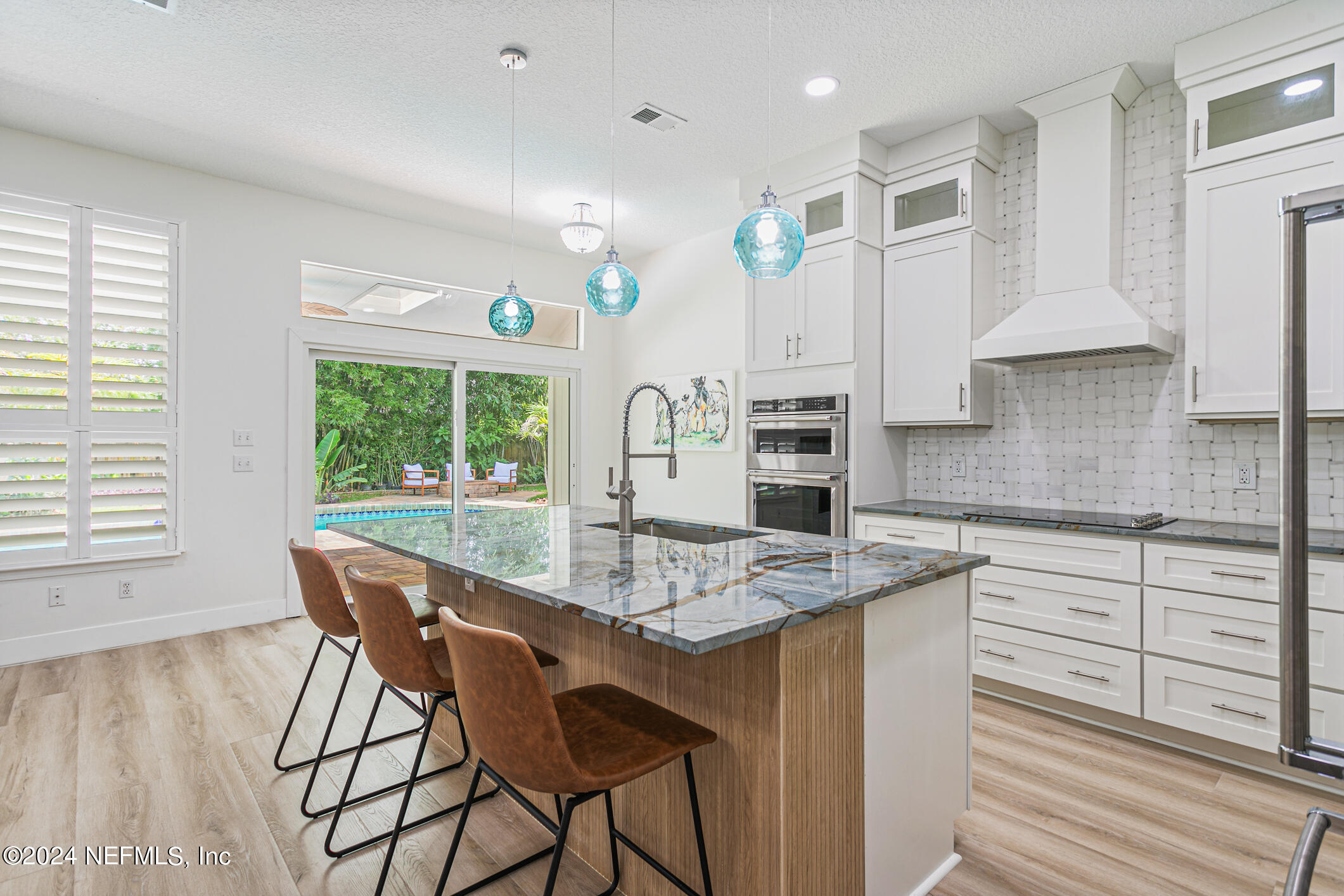 622 Cherry Street Neptune Beach, FL 32266 - Photo 8 of 77 a kitchen with stainless steel appliances granite countertop a stove top oven a sink dishwasher and white cabinets with wooden floor