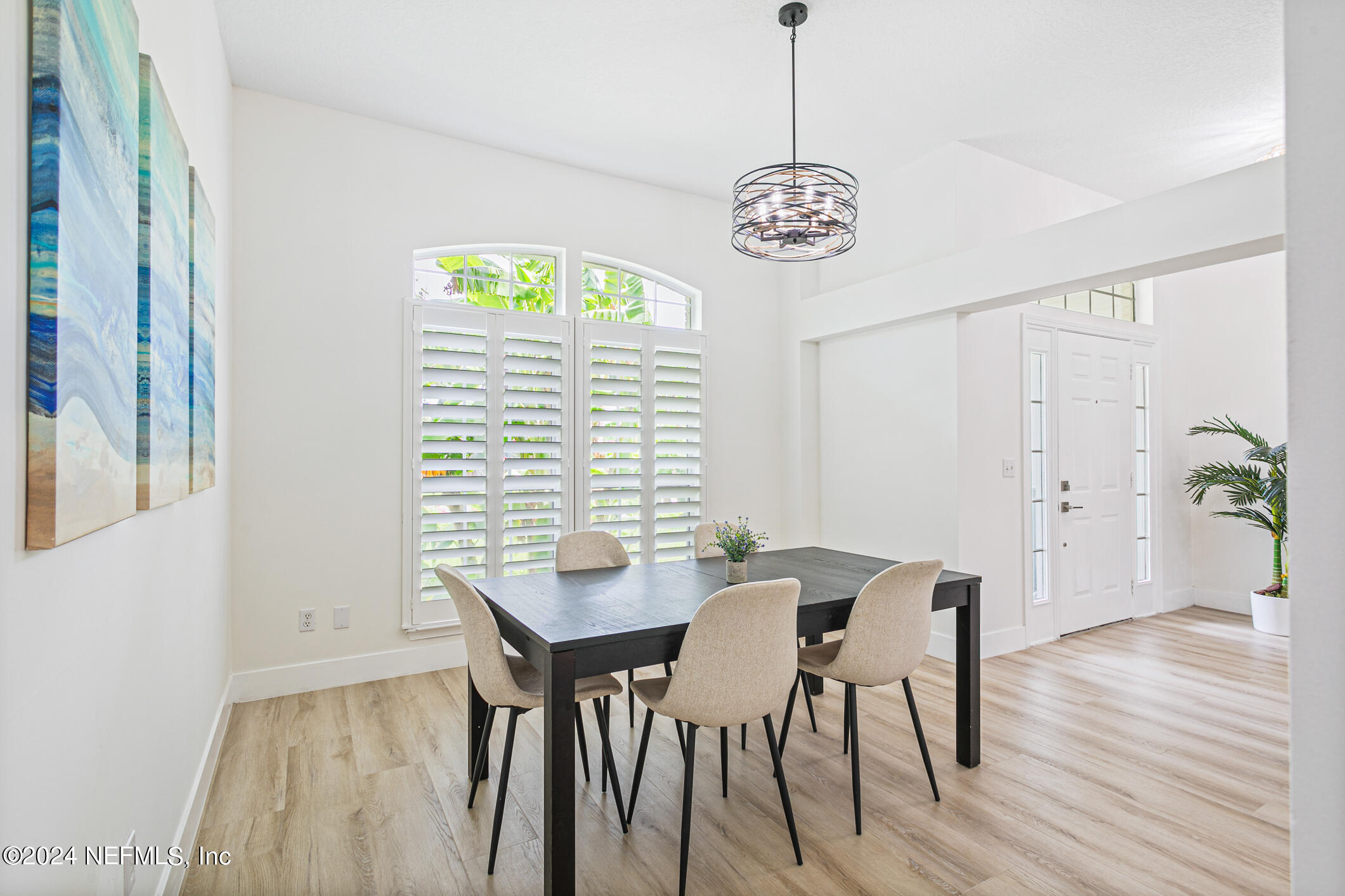 622 Cherry Street Neptune Beach, FL 32266 - Photo 9 of 77 a view of a dining room with furniture wooden floor and a chandelier