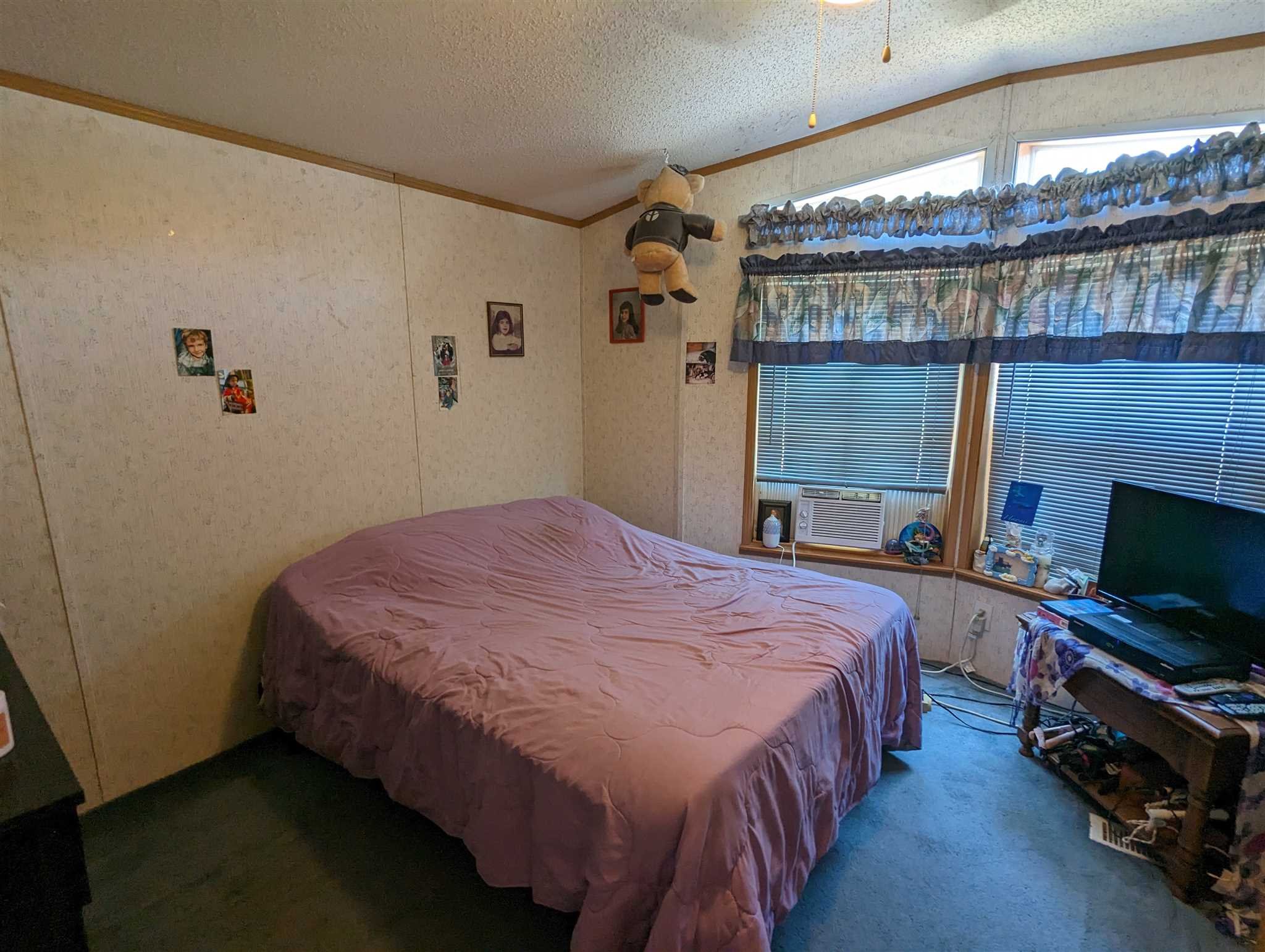 9 Depew Park Wallkill, NY 12589 - Photo 15 of 19 a bedroom with a bed and a flat tv screen on the dresser