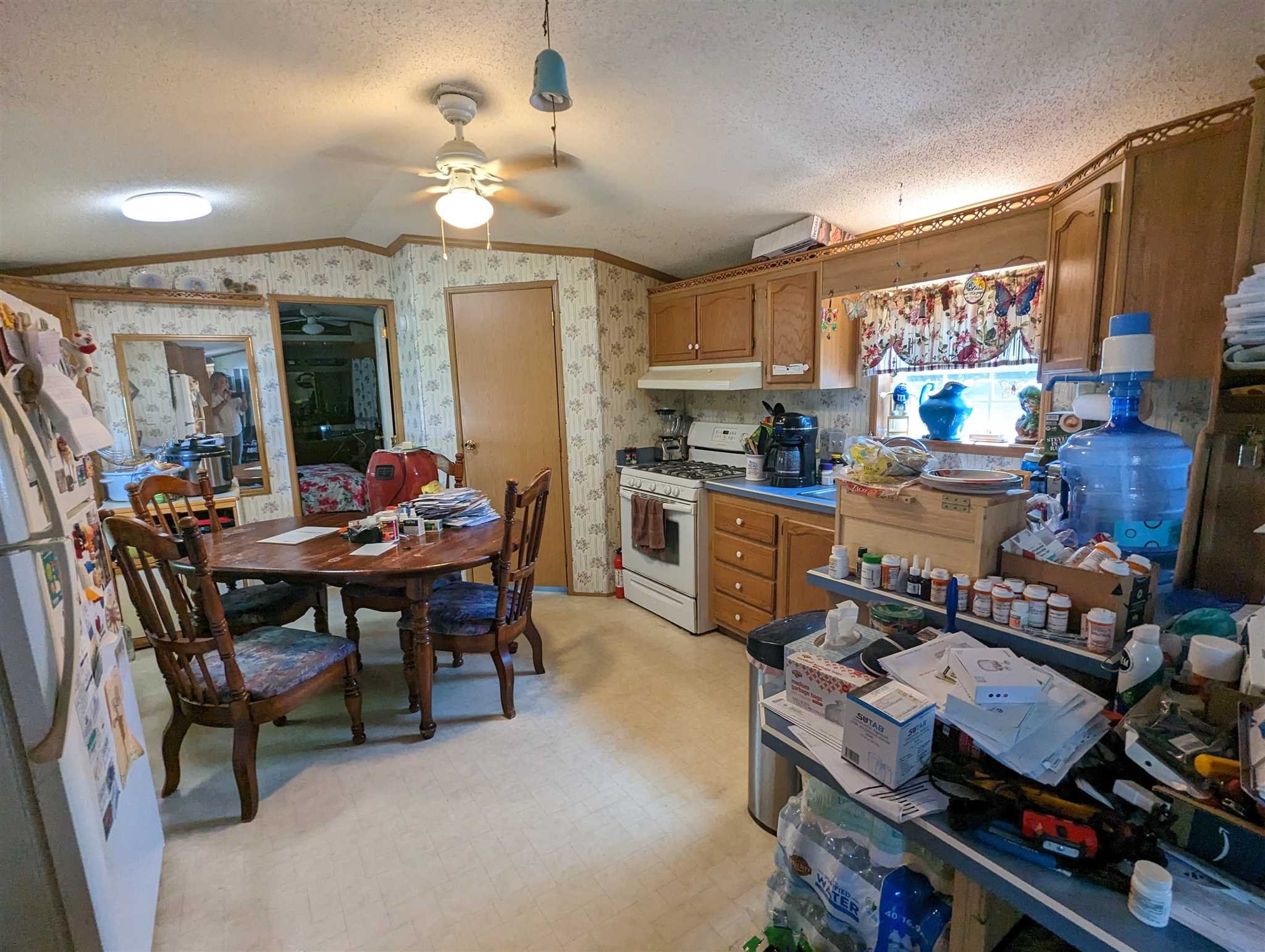9 Depew Park Wallkill, NY 12589 - Photo 6 of 19 a open kitchen with stainless steel appliances granite countertop a stove a refrigerator a dining table and chairs with wooden floor