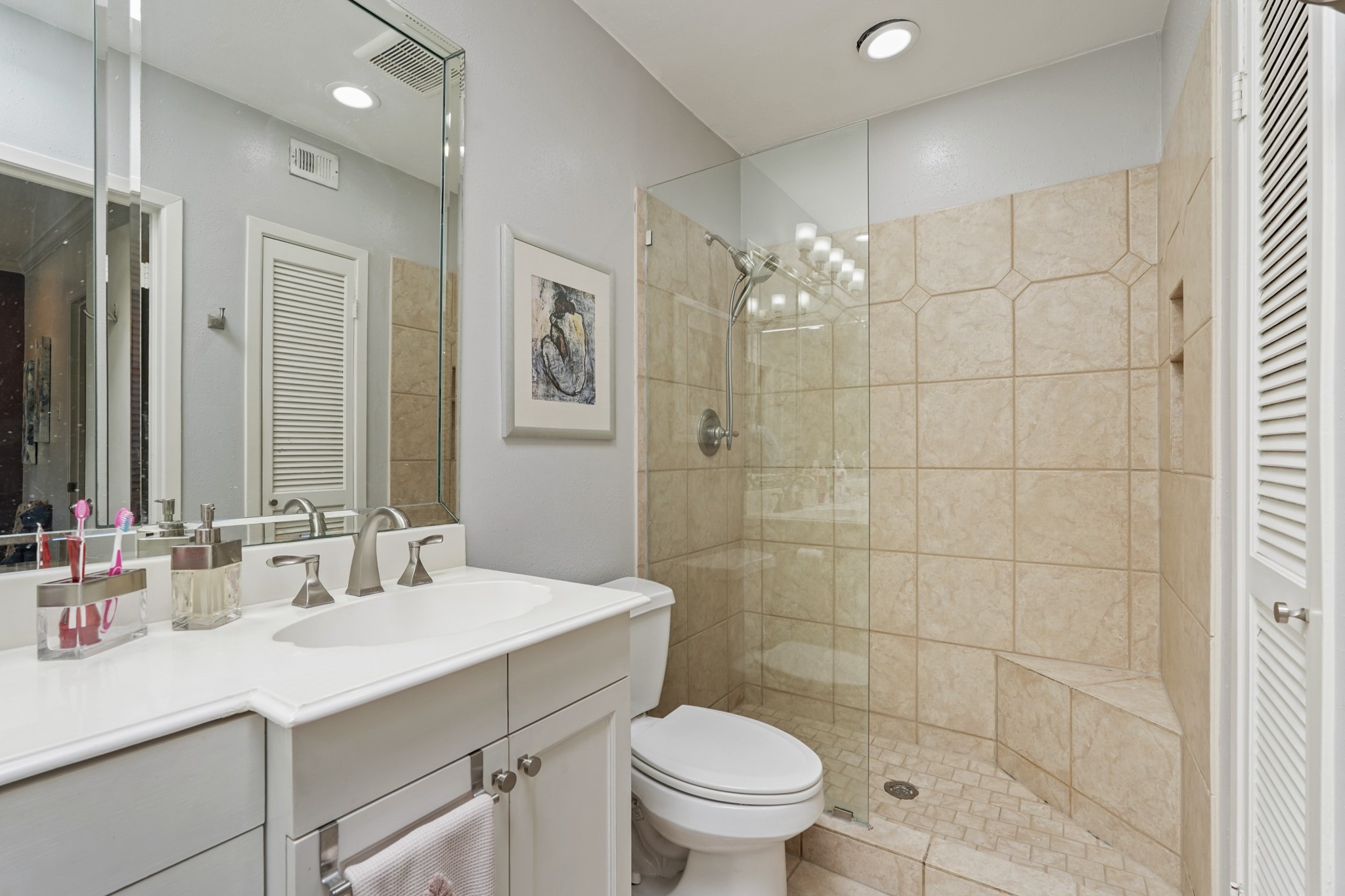2236 South Piney Point Road, Unit 101 Houston, TX 77063 - Photo 13 of 21 Stand alone glass enclosed shower with a seating area, and tile walls.