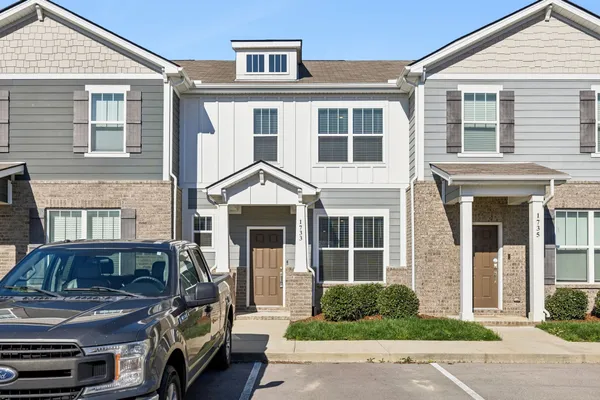 a kitchen with a refrigerator and a stove
