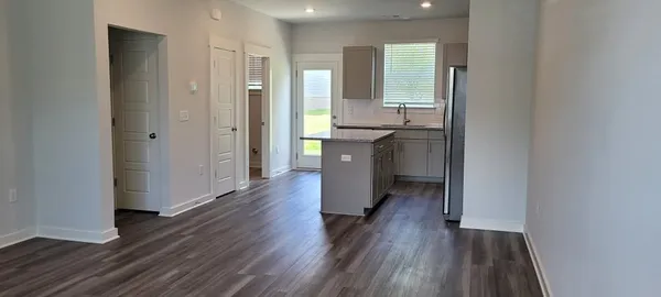 a kitchen with stainless steel appliances granite countertop a sink and a stove