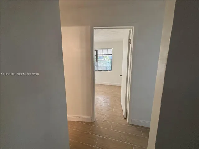 a view of an empty room with windows