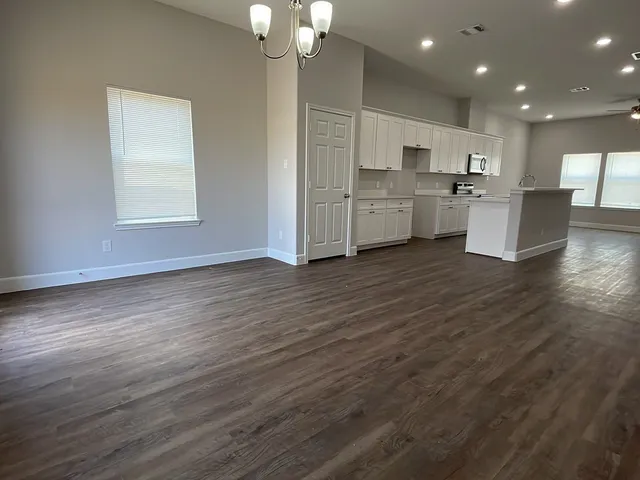 a view of kitchen with wooden floor and window