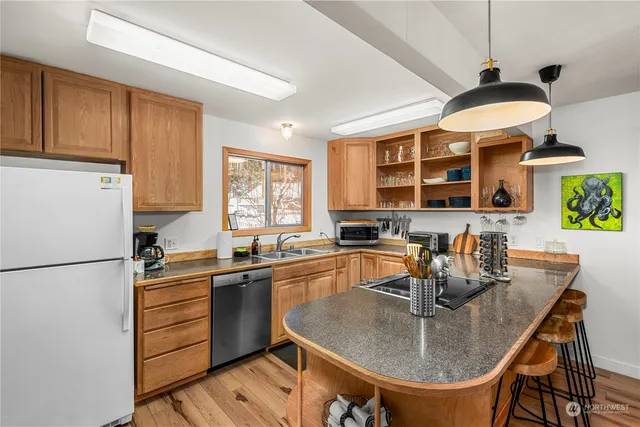 a kitchen with a sink refrigerator and cabinets