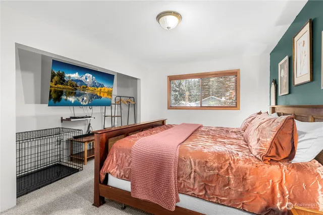 a bedroom with a bed and a flat screen tv