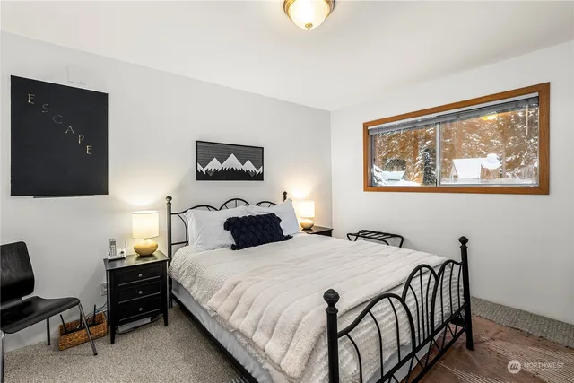 a bathroom with a granite countertop sink toilet and mirror