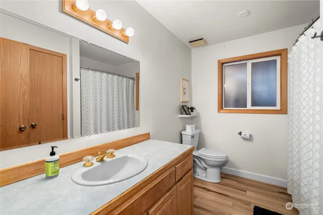 a front view of a house with a garden and trees