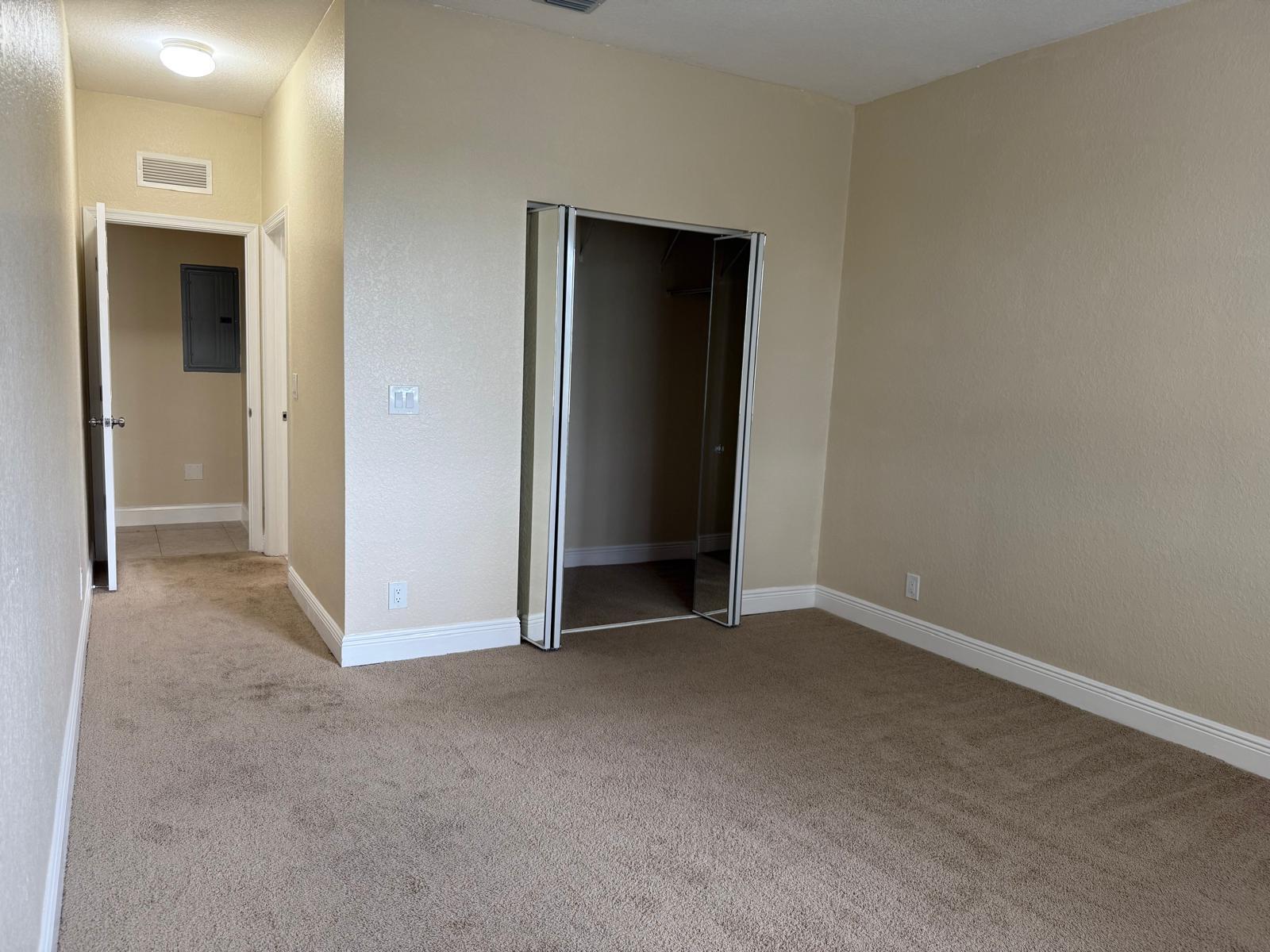 3569 Forest Hill Boulevard, Unit 110 Palm Springs, FL 33406 - Photo 12 of 23 an empty room with closet and a bathroom