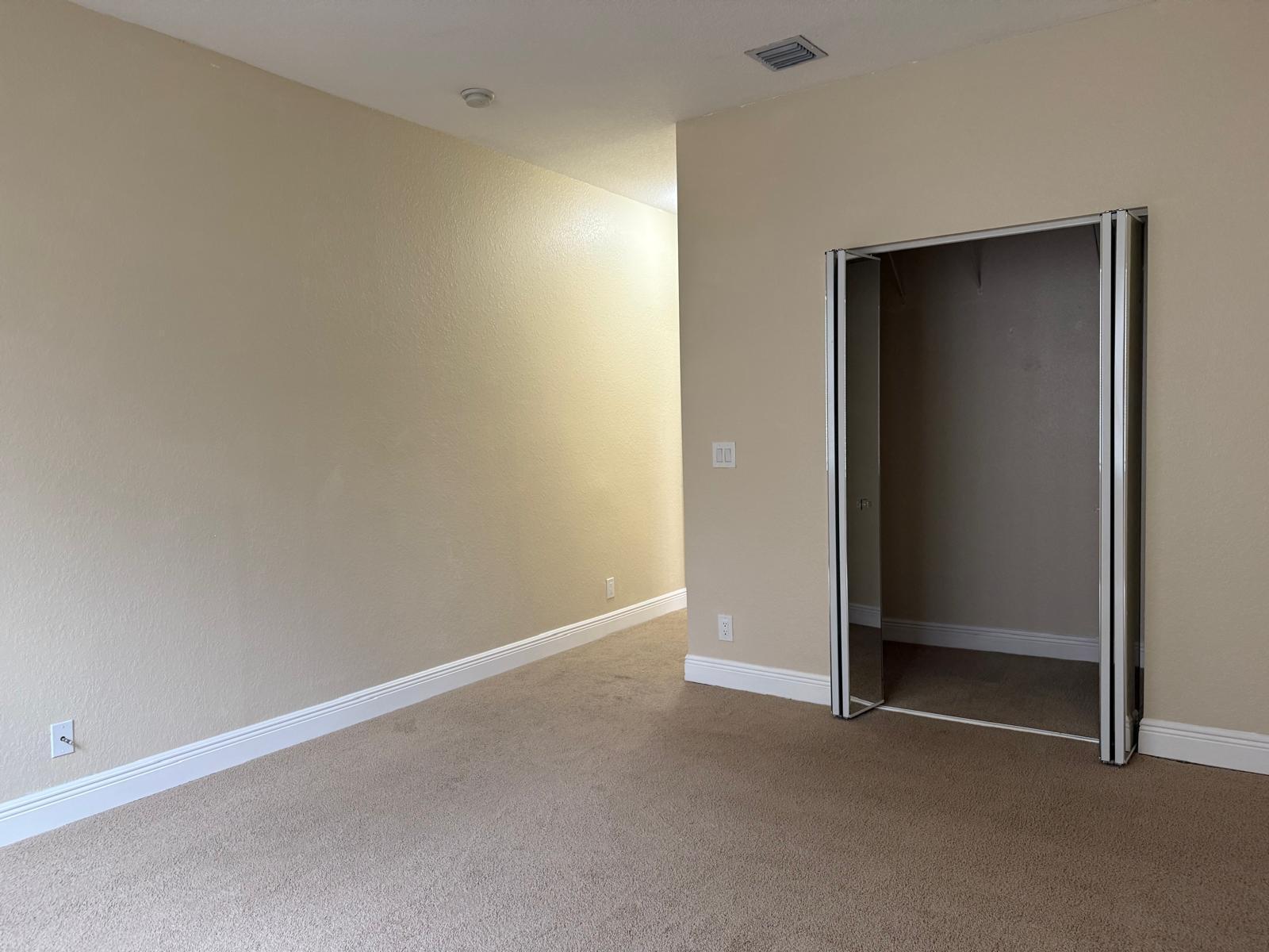 3569 Forest Hill Boulevard, Unit 110 Palm Springs, FL 33406 - Photo 15 of 23 an empty room with closet