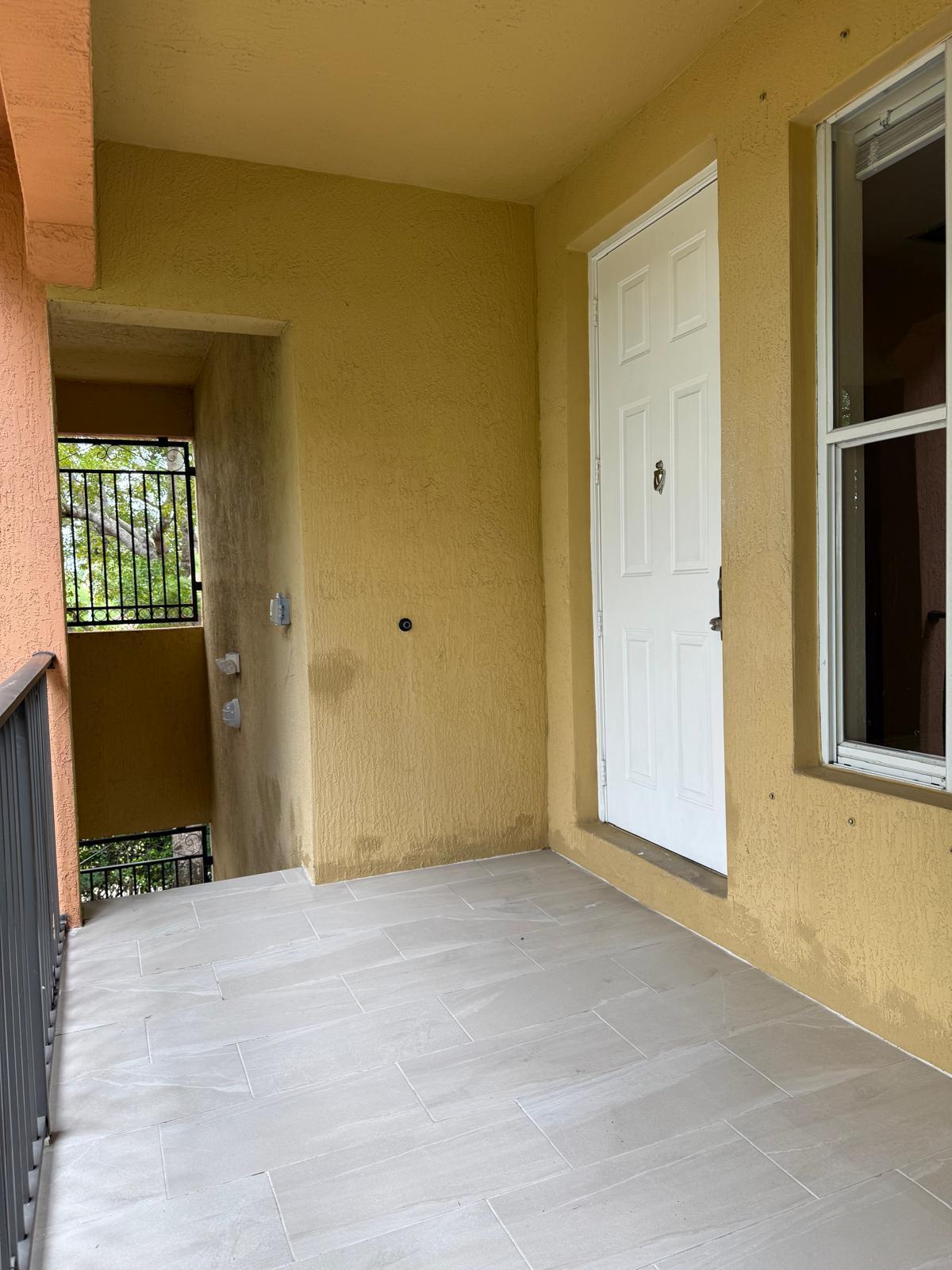 3569 Forest Hill Boulevard, Unit 110 Palm Springs, FL 33406 - Photo 7 of 23 an empty room with windows