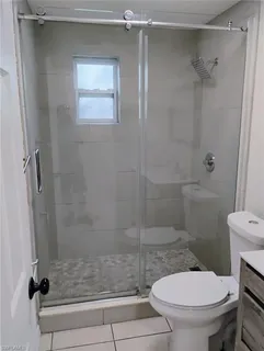 a bathroom with a toilet and a shower