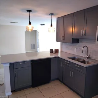 a kitchen with a sink and cabinets