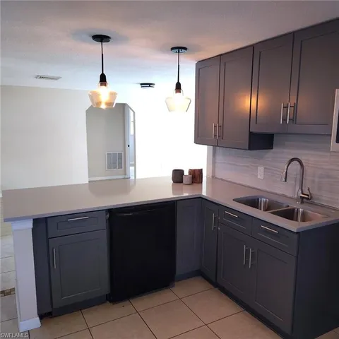 a kitchen with a sink and cabinets