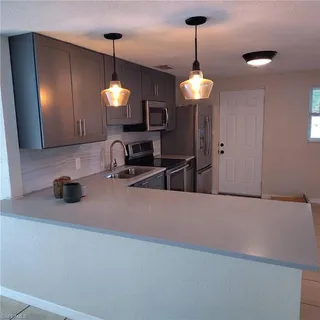 a kitchen with a sink and a refrigerator