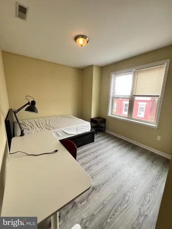 a bed room with a bed and a window