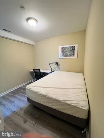 a large bed sitting in a bedroom next to a wall