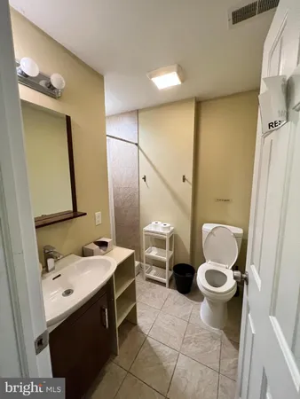 a bathroom with a sink toilet and mirror