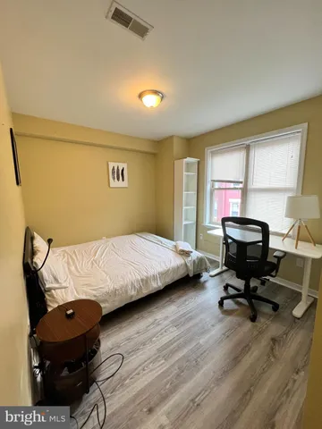 a bedroom with bed and window