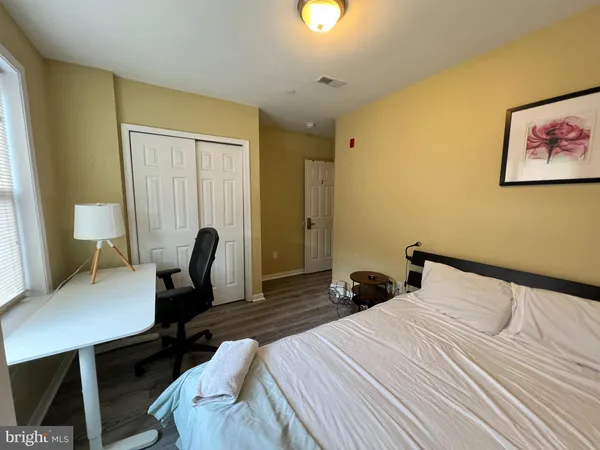 a bedroom with a bed and a desk