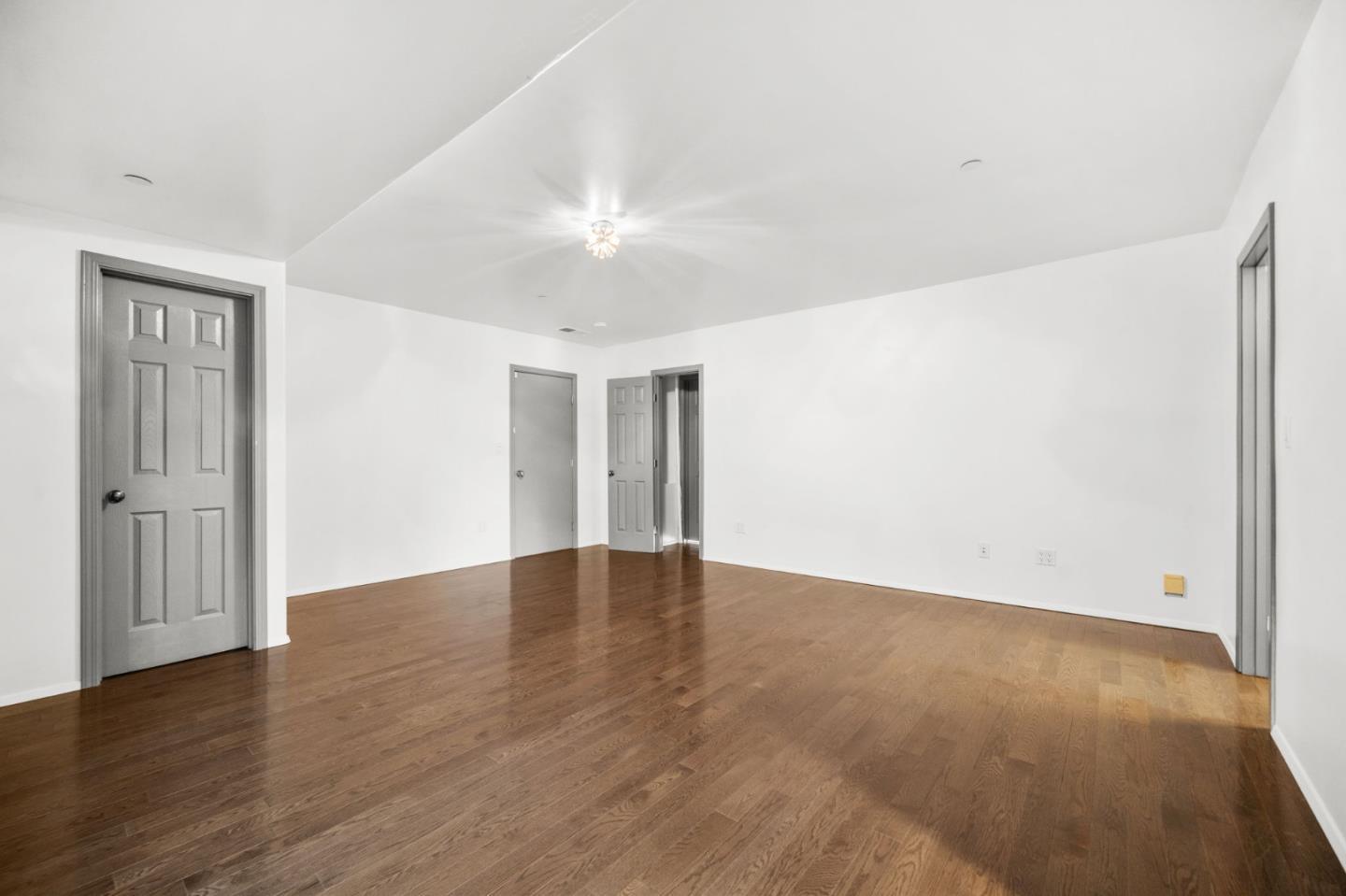 15 Anson Road, Unit B Hillsborough, CA 94010 - Photo 16 of 25 an empty room with wooden floor and windows