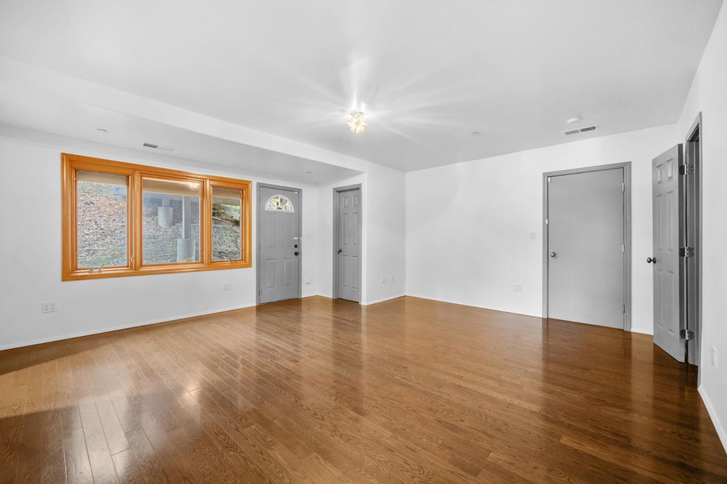15 Anson Road, Unit B Hillsborough, CA 94010 - Photo 18 of 25 a view of an empty room with window and wooden floor