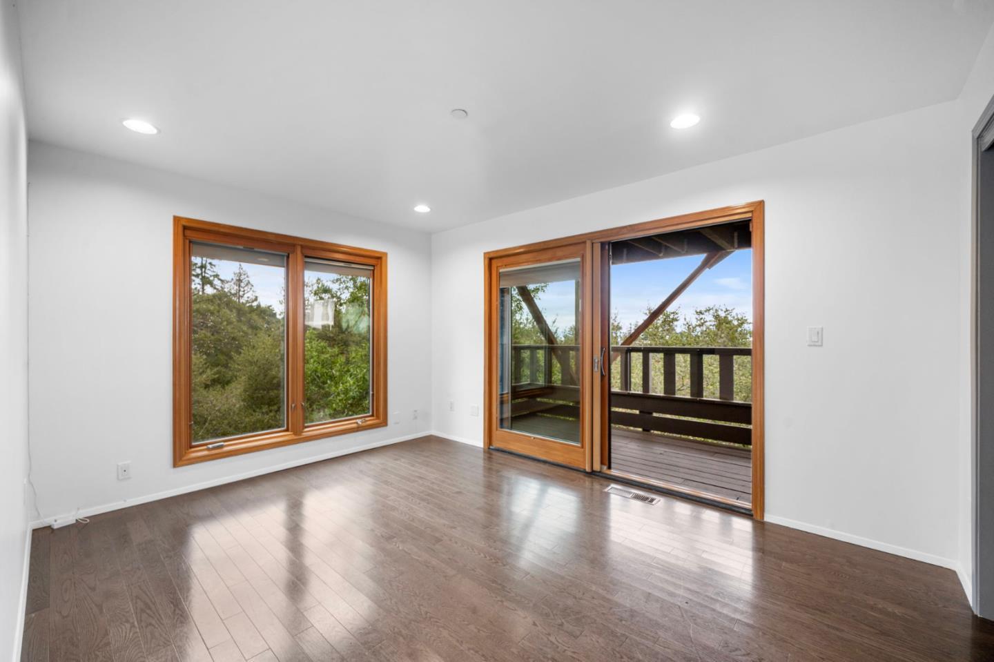 15 Anson Road, Unit B Hillsborough, CA 94010 - Photo 19 of 25 an empty room with wooden floor and windows