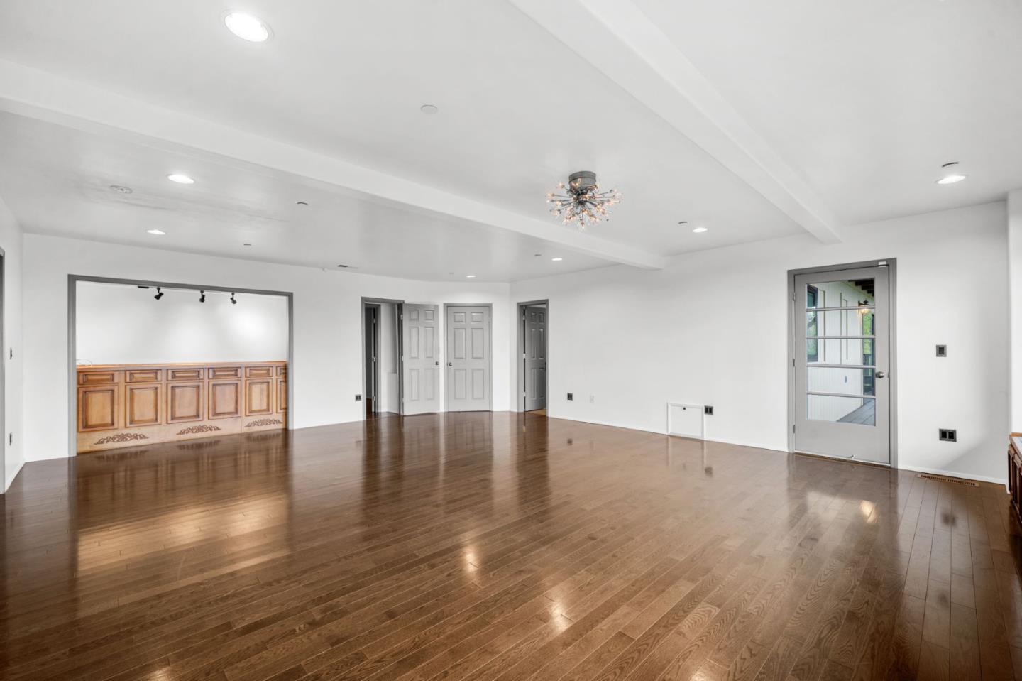 15 Anson Road, Unit B Hillsborough, CA 94010 - Photo 22 of 25 a view of an empty room with wooden floor and a window