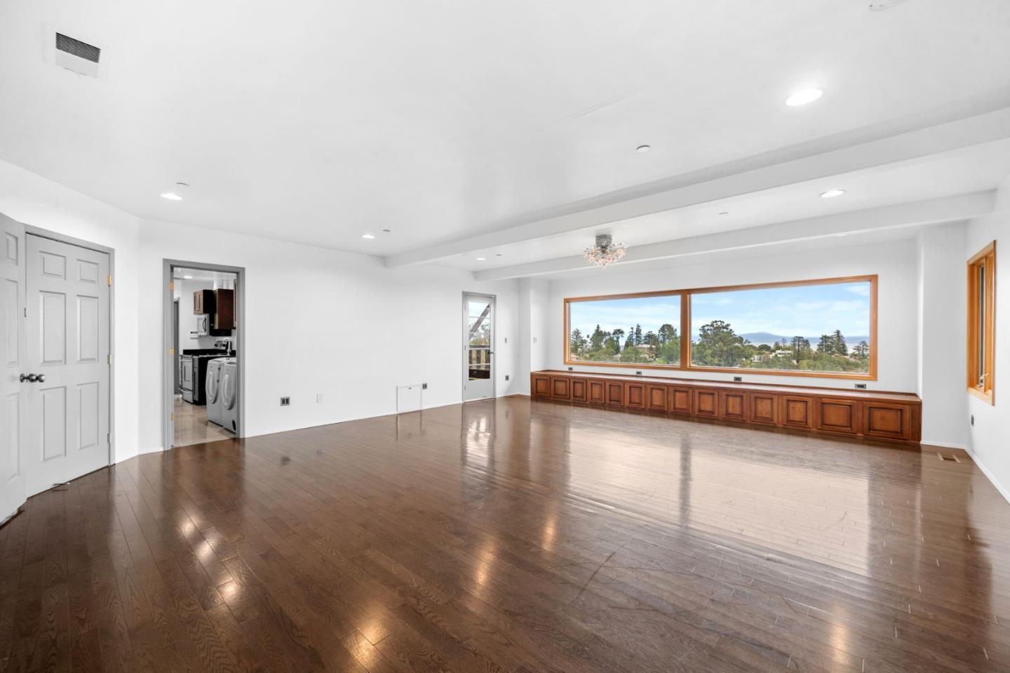 15 Anson Road, Unit B Hillsborough, CA 94010 - Photo 23 of 25 a view of a living room and floor to ceiling window and wooden floor