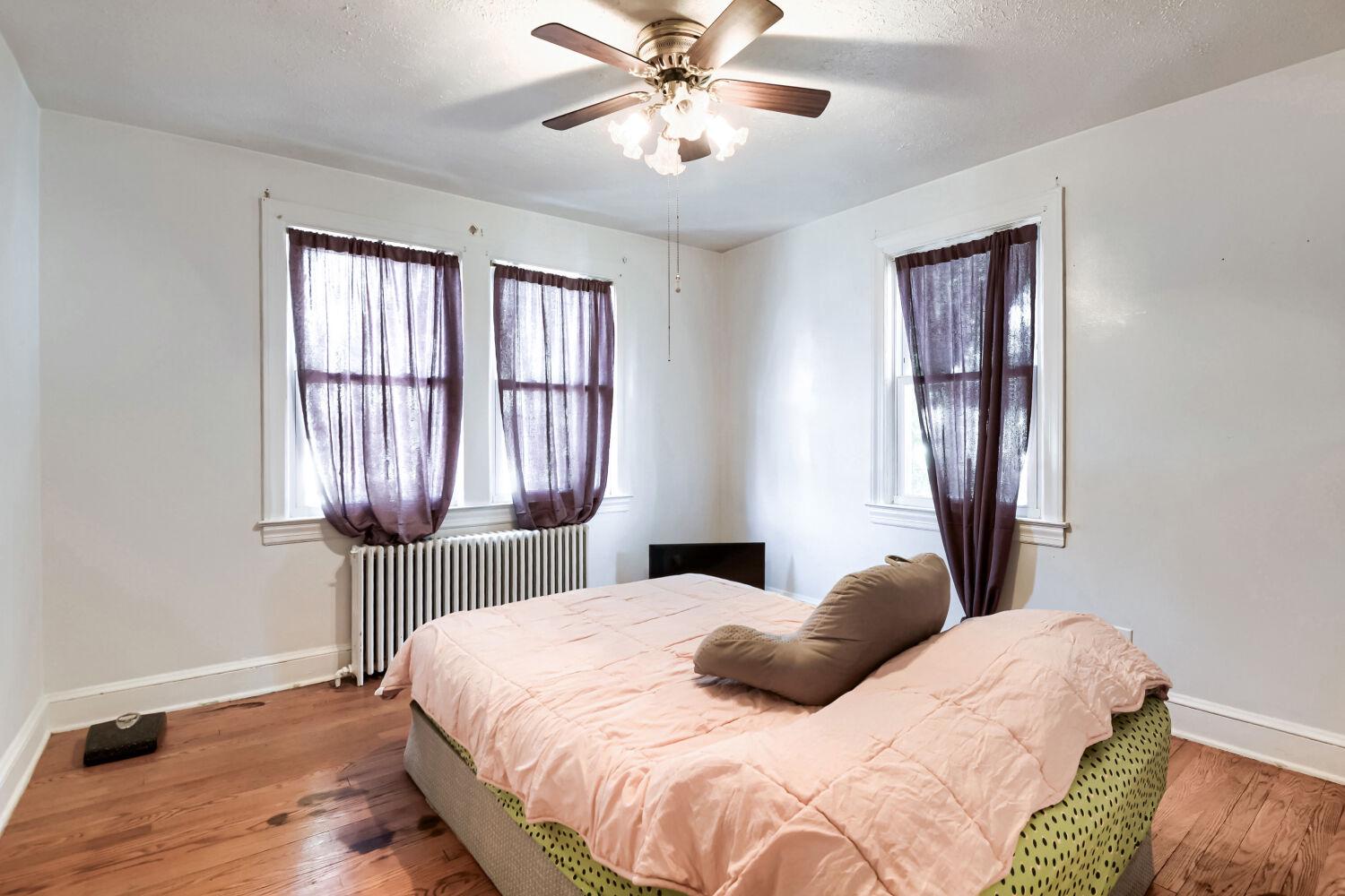217 Doris Avenue Baltimore, MD 21225 - Photo 8 of 16 a bedroom with a bed and a window
