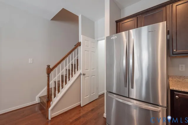 a view of a kitchen with wooden floor and staircase