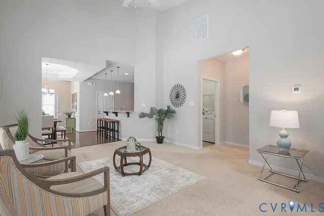 a living room with furniture and a chandelier