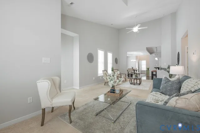 a living room with furniture and a chandelier