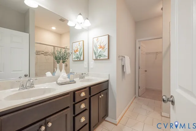a bathroom with a double vanity sink mirror and shower