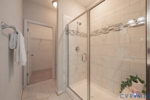 a bathroom with a shower and a glass door