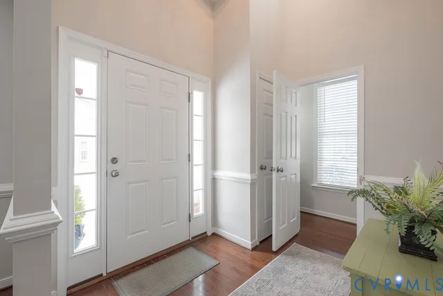 a view of entryway with window and wooden floor
