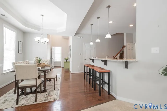 a view of a a dining room with furniture window and wooden floor