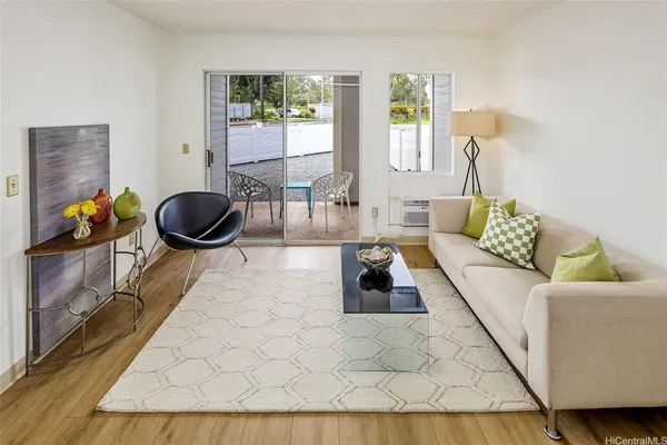 a living room with furniture and a wooden floor