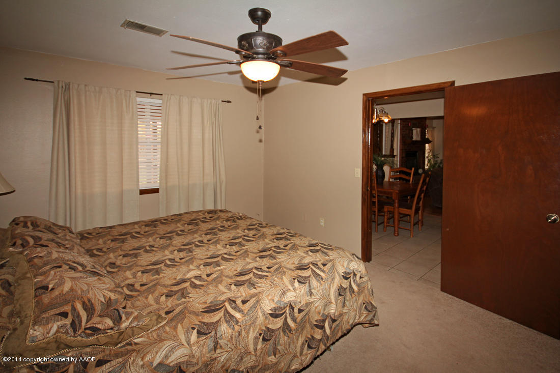 5320 Wheeler Lane Amarillo, TX 79110 - Photo 13 of 23 a bedroom with a bed and a chandelier