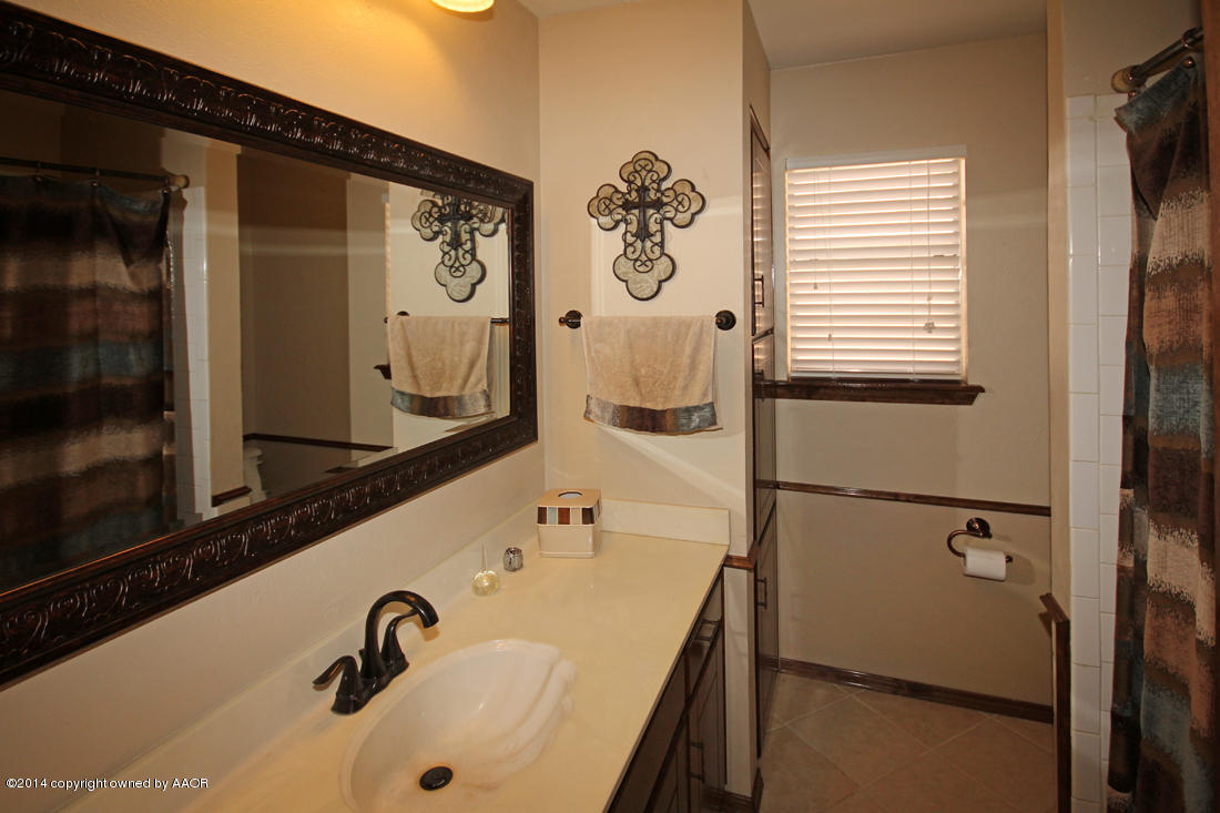 5320 Wheeler Lane Amarillo, TX 79110 - Photo 19 of 23 a bathroom with a sink and mirror