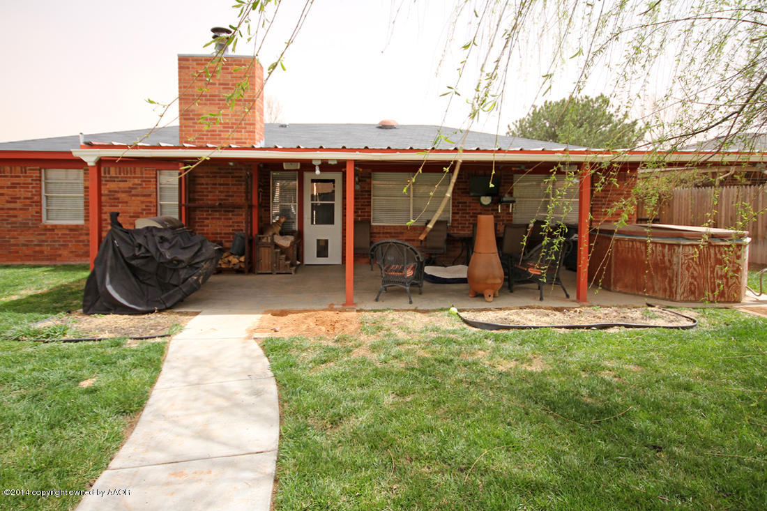 5320 Wheeler Lane Amarillo, TX 79110 - Photo 21 of 23 a view of a patio with table and chairs a barbeque with wooden fence