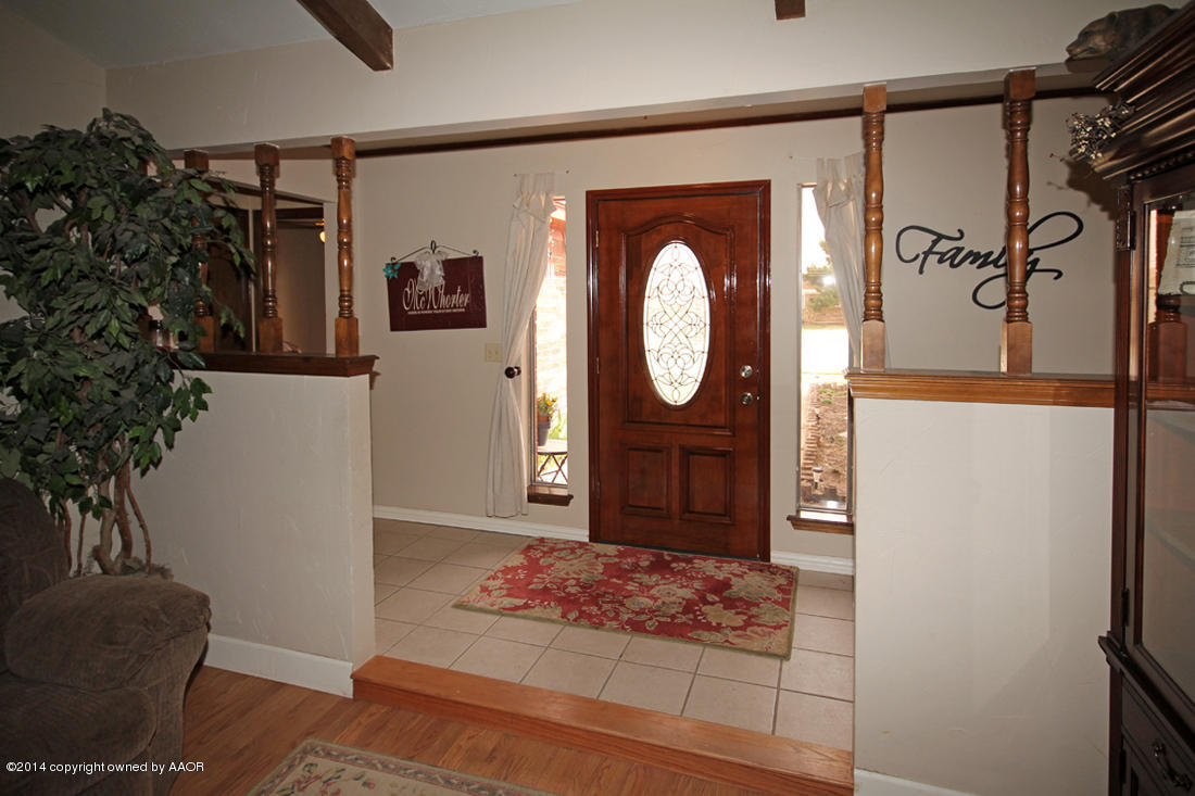 5320 Wheeler Lane Amarillo, TX 79110 - Photo 3 of 23 a view of a hallway with entryway wooden floor and front door