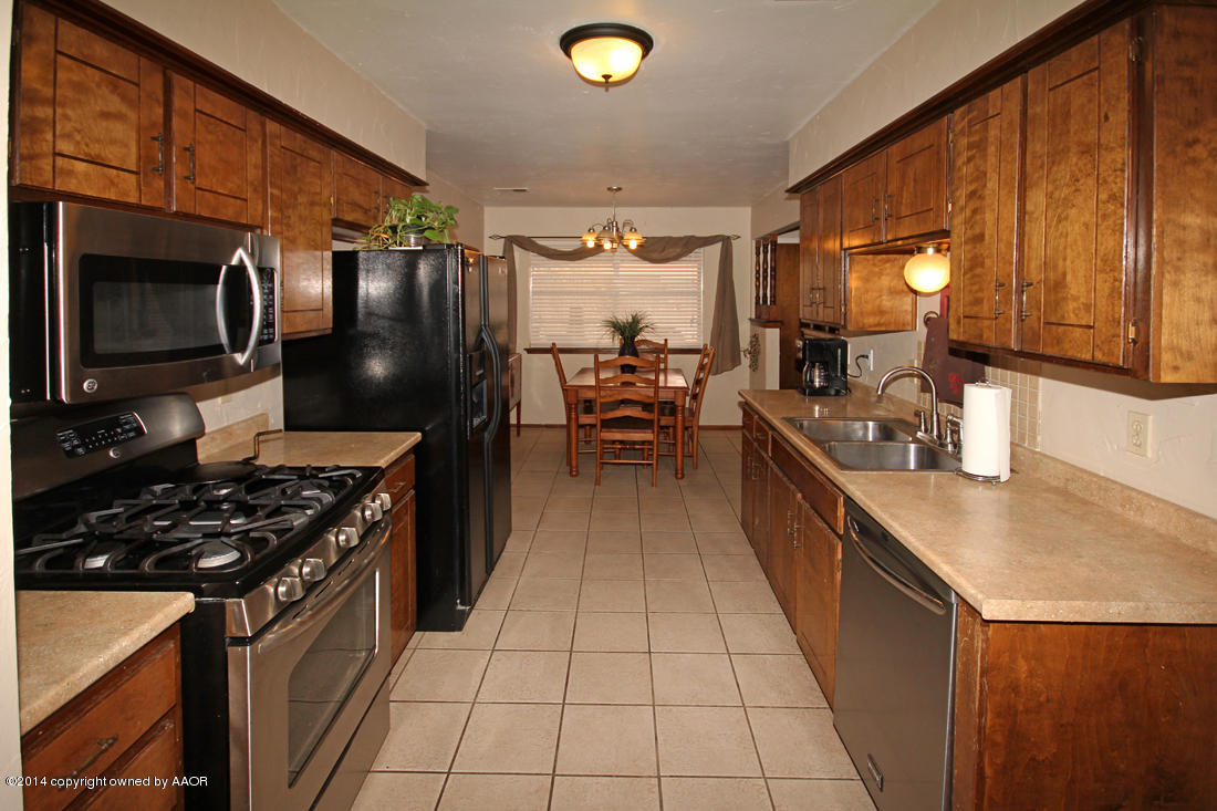 5320 Wheeler Lane Amarillo, TX 79110 - Photo 8 of 23 a kitchen with stainless steel appliances a stove a sink and a microwave