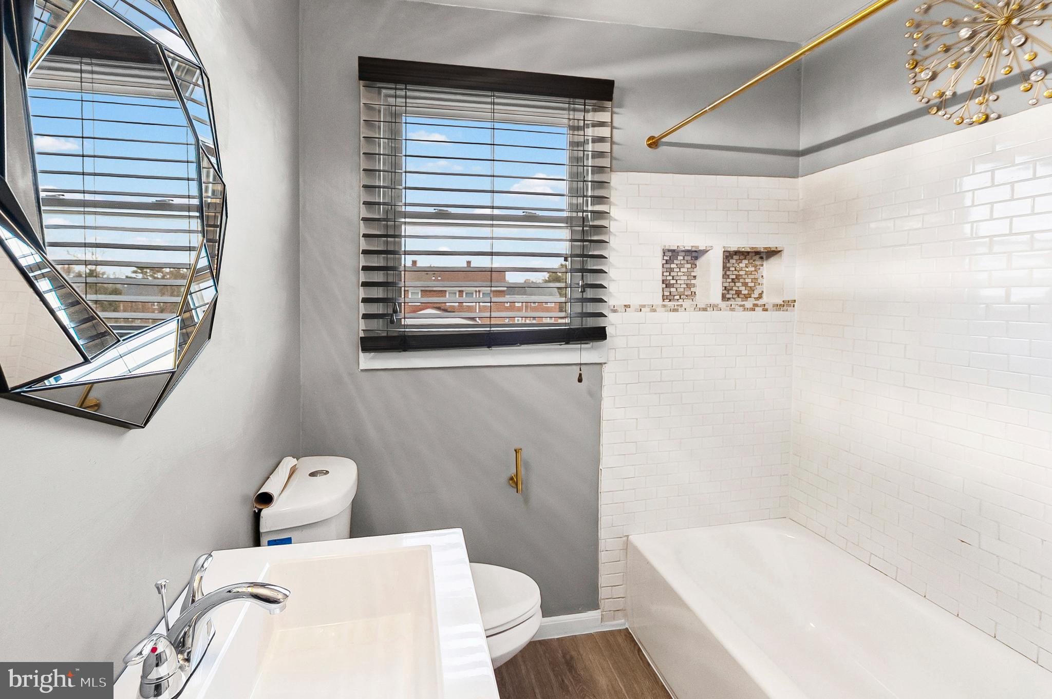 6955 Blanche Road Baltimore, MD 21215 - Photo 17 of 26 a bathroom with a bathtub and shower